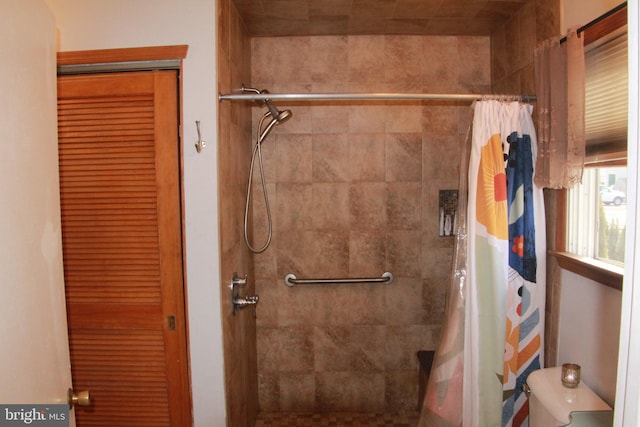 bathroom with toilet and walk in shower