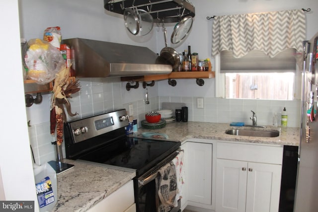 kitchen with sink, white cabinets, backsplash, stainless steel appliances, and light stone countertops