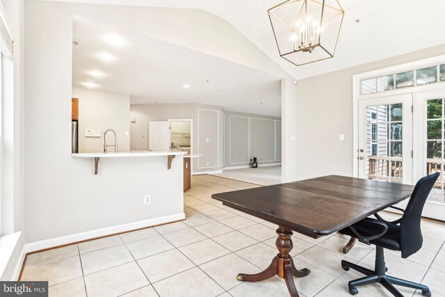 office area with lofted ceiling, light tile patterned floors, a chandelier, and baseboards