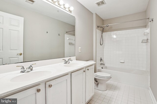 full bath featuring washtub / shower combination, tile patterned flooring, visible vents, and a sink