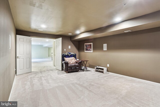 living area featuring baseboards, recessed lighting, visible vents, and light colored carpet