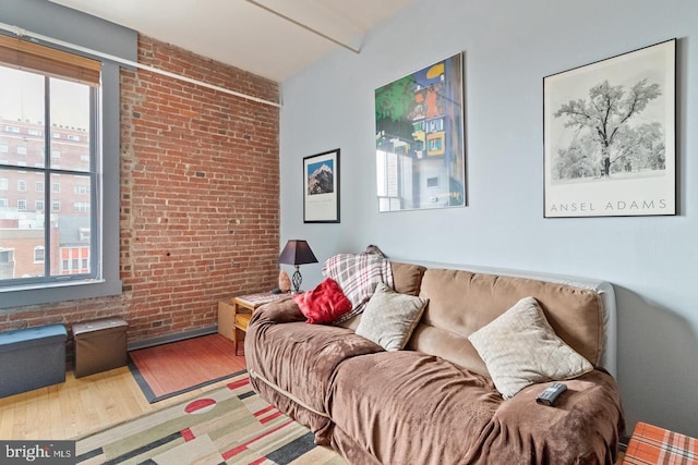1010 Race St Unit 5D, Philadelphia, PA 19107 - living room with hardwood / wood-style flooring, brick wall, and beam ceiling