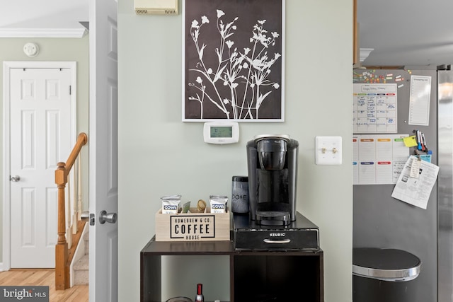 interior space with freestanding refrigerator, visible vents, and wood finished floors