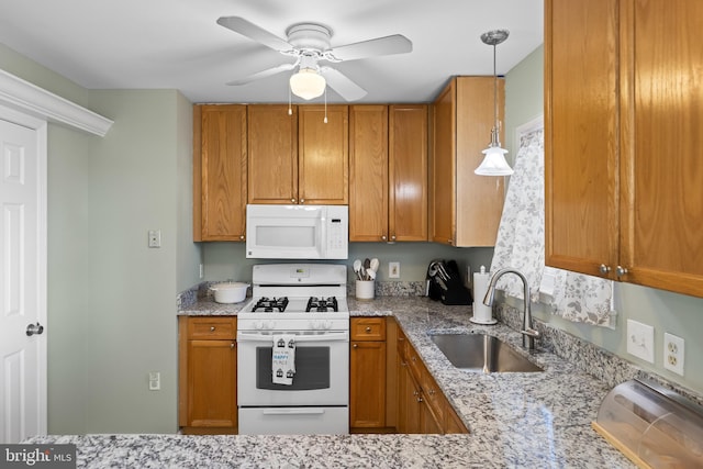 kitchen featuring white appliances, brown cabinets, and a sink