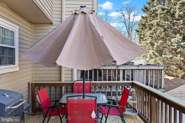 deck featuring outdoor dining area and area for grilling