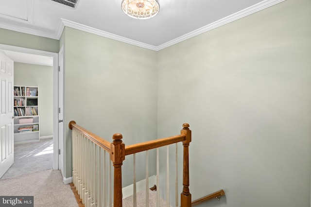 hall with crown molding, baseboards, carpet flooring, and an upstairs landing