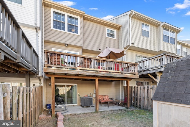 back of property with a patio area, fence, a deck, and central AC