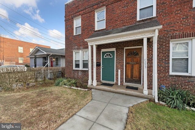 entrance to property with a lawn