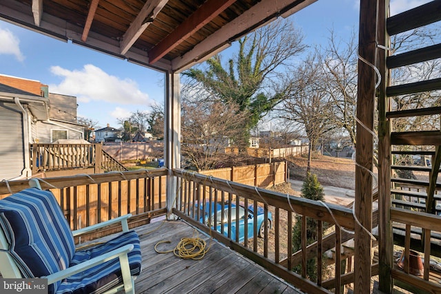 wooden terrace with a swimming pool