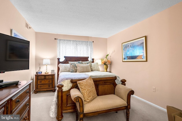 carpeted bedroom featuring a textured ceiling