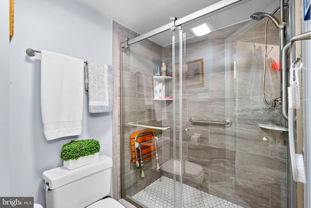 bathroom with toilet and an enclosed shower