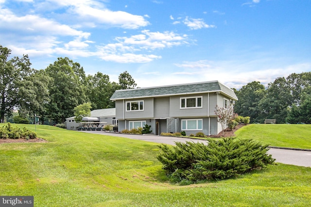 view of front of home featuring a garage and a front lawn