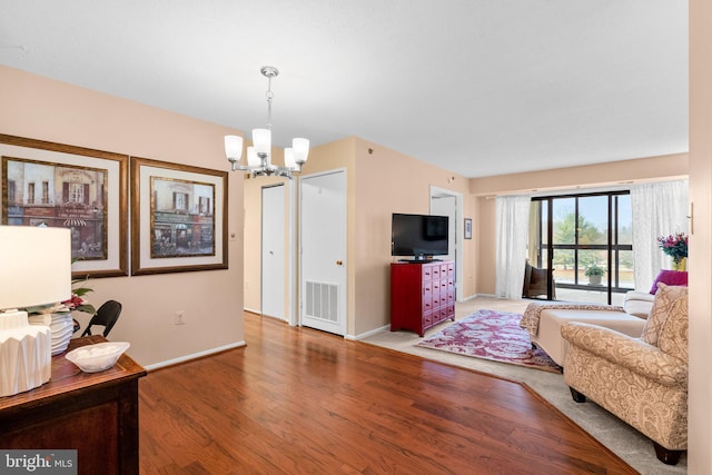 living room featuring an inviting chandelier and hardwood / wood-style floors