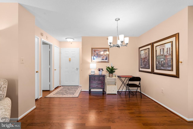 entrance foyer featuring dark hardwood / wood-style floors and a chandelier