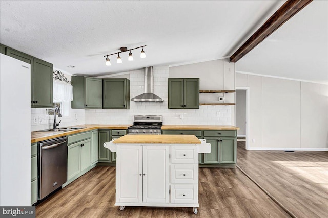 kitchen featuring wall chimney exhaust hood, wood counters, and green cabinetry