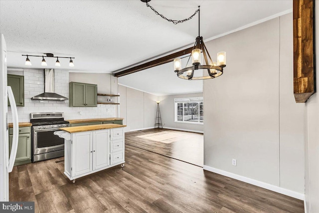 kitchen with lofted ceiling with beams, stainless steel gas range oven, wooden counters, wall chimney range hood, and green cabinetry