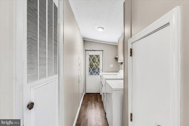 laundry room with laundry area, a heating unit, wood finished floors, washing machine and clothes dryer, and a textured ceiling