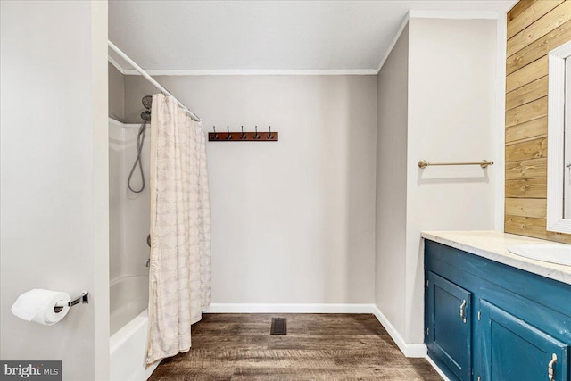 full bathroom with ornamental molding, wood finished floors, visible vents, and baseboards