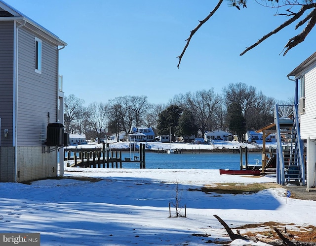 yard covered in snow featuring stairway