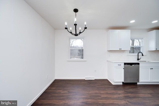 kitchen with dishwasher, hanging light fixtures, white cabinets, dark hardwood / wood-style flooring, and decorative backsplash