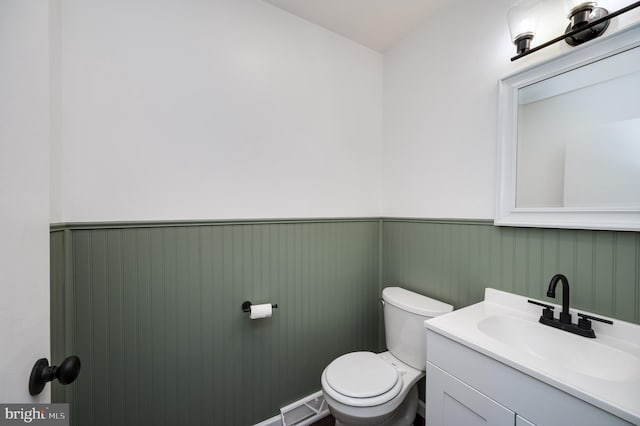 bathroom featuring vanity and toilet