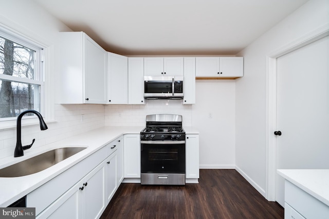 kitchen featuring white cabinetry, tasteful backsplash, sink, and range with gas cooktop