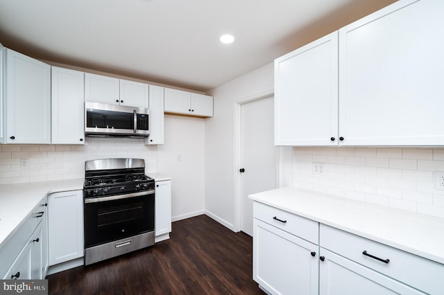 kitchen featuring stainless steel appliances, dark hardwood / wood-style flooring, decorative backsplash, and white cabinets