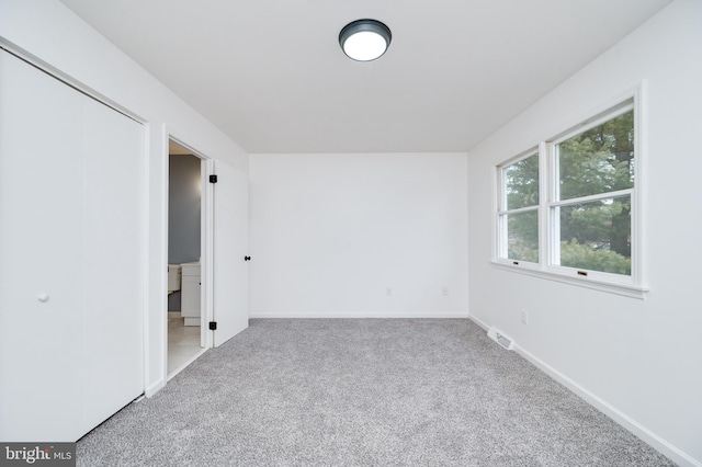 unfurnished bedroom with carpet floors and a closet