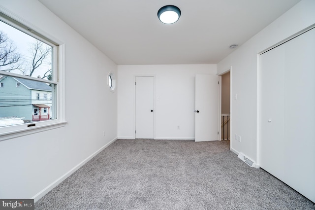 unfurnished bedroom featuring light colored carpet