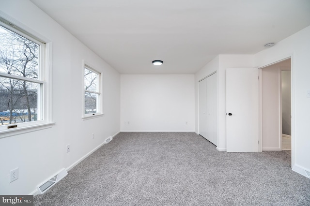 unfurnished bedroom featuring a closet and carpet