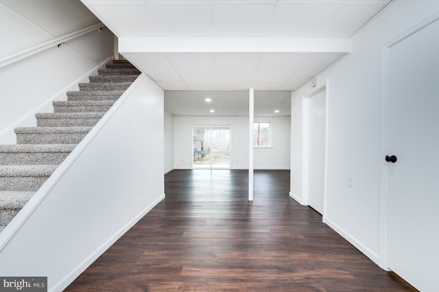 interior space featuring dark hardwood / wood-style floors and a drop ceiling