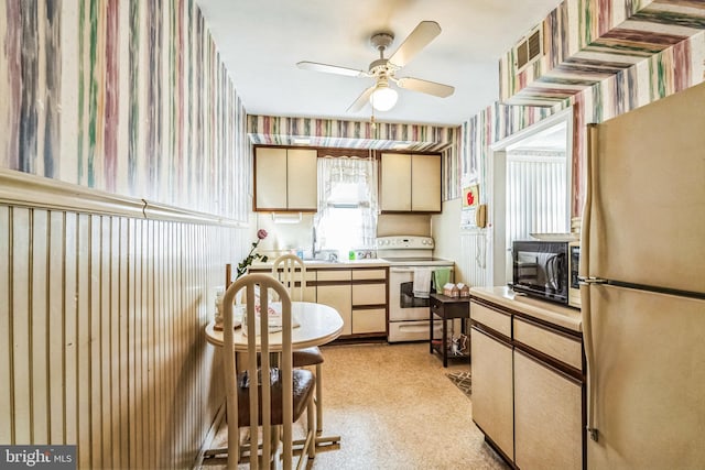 kitchen with fridge, ceiling fan, and electric range