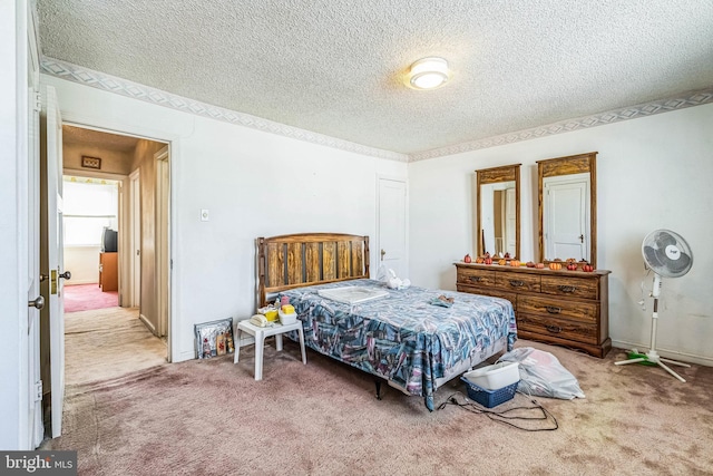 bedroom featuring a textured ceiling and carpet flooring