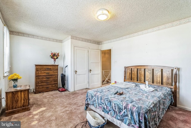 bedroom featuring carpet flooring and a textured ceiling