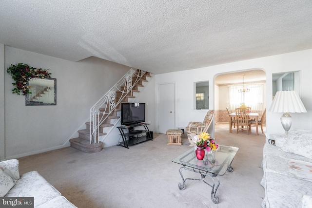 living room featuring carpet flooring and a textured ceiling