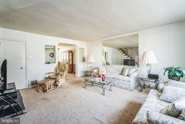 living room featuring light colored carpet and a textured ceiling