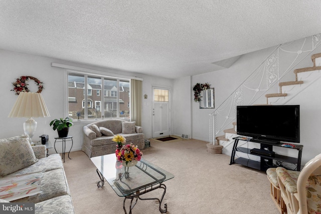 carpeted living room with a textured ceiling