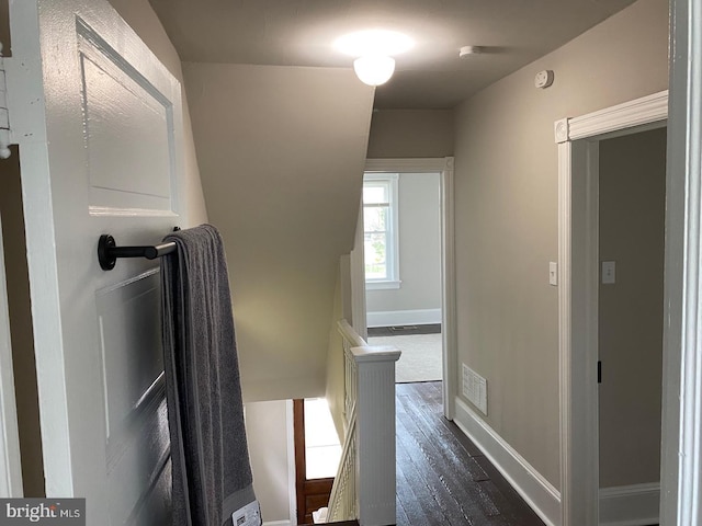 corridor with dark hardwood / wood-style flooring