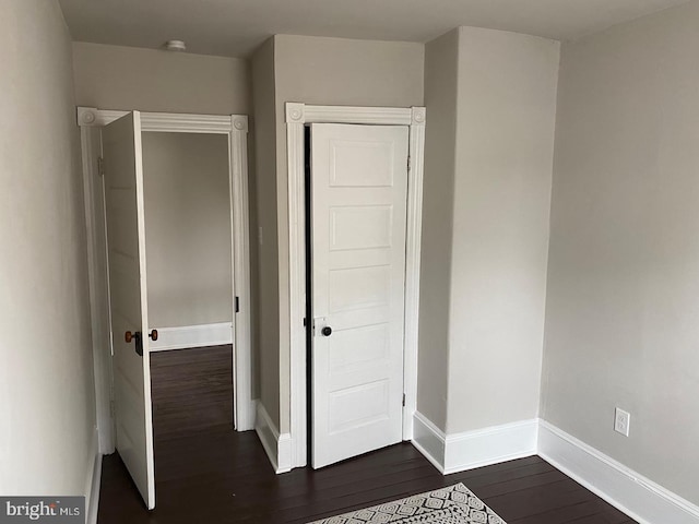 unfurnished bedroom with dark wood-type flooring