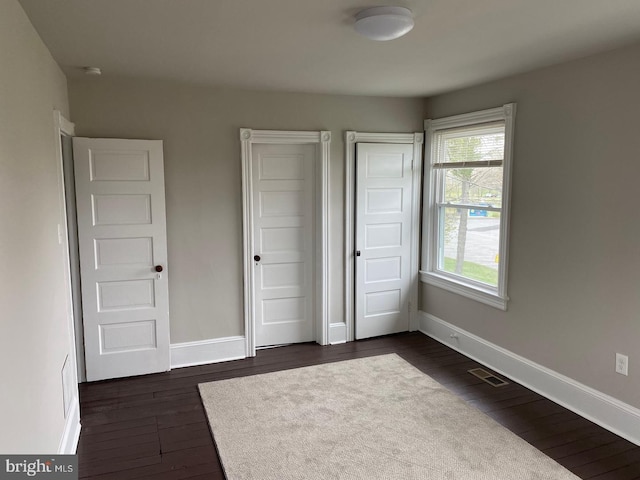 unfurnished bedroom featuring dark wood-type flooring