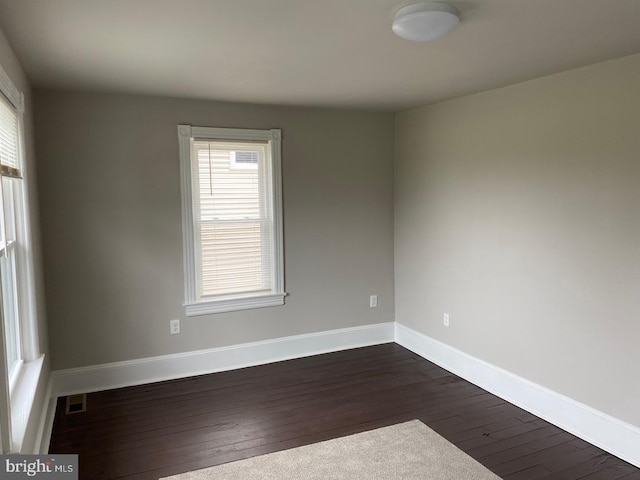 unfurnished room featuring dark hardwood / wood-style floors