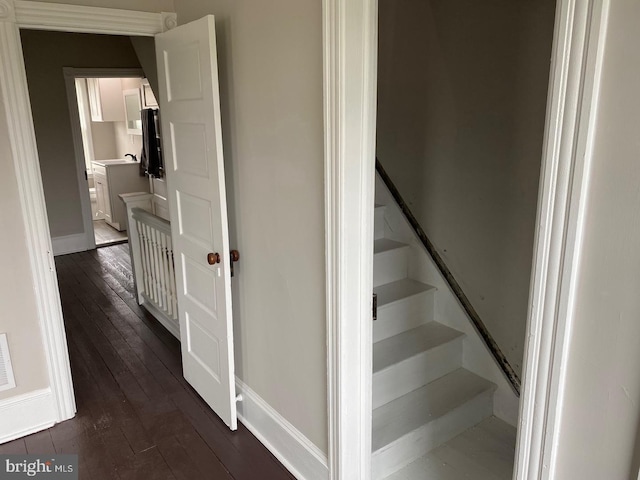 stairway with hardwood / wood-style floors