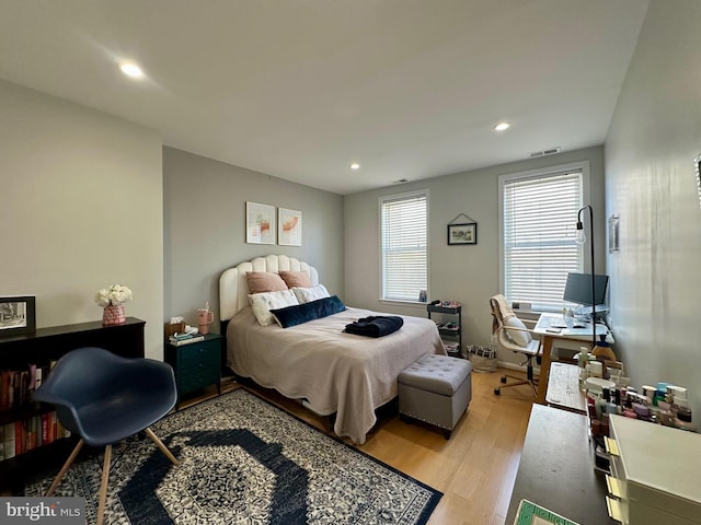 bedroom with recessed lighting, light wood-type flooring, and visible vents