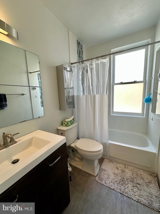 full bathroom with tile patterned floors, shower / bath combination with curtain, toilet, and vanity