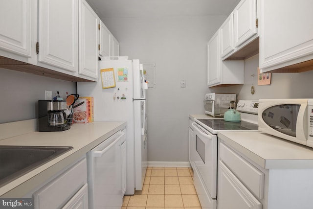 kitchen featuring white appliances, white cabinets, and light countertops