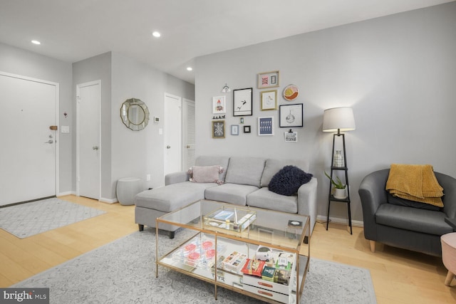 living area featuring recessed lighting, baseboards, and wood finished floors