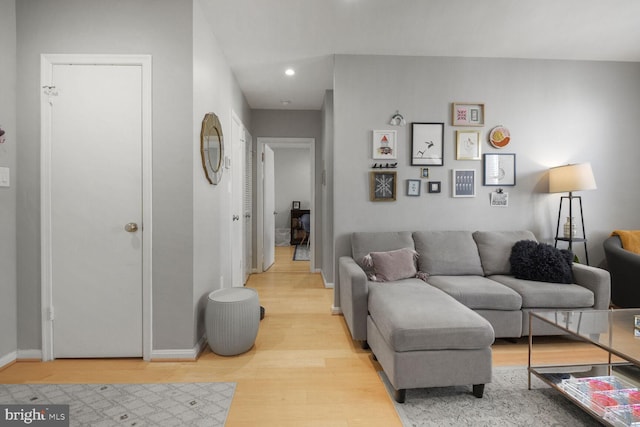 living area with recessed lighting, baseboards, and light wood-style floors