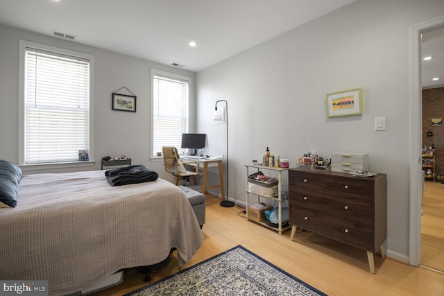 bedroom featuring light wood-style flooring, baseboards, and visible vents