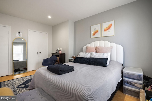 bedroom with recessed lighting and wood finished floors