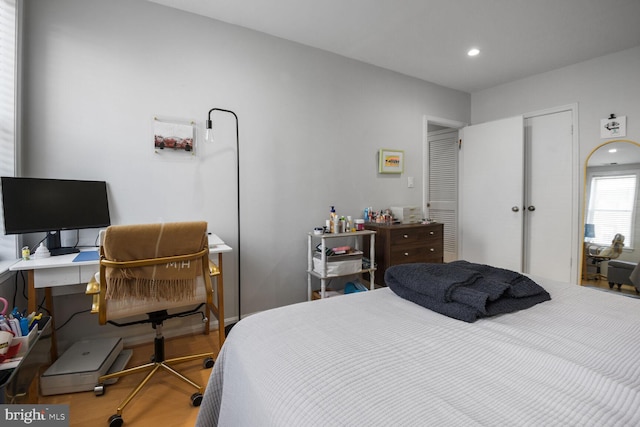 bedroom with recessed lighting and wood finished floors